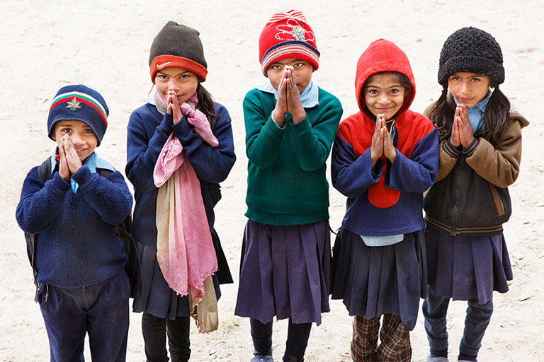Nepalese children giving namaste greeting